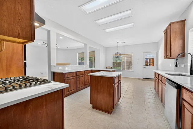 a kitchen with stainless steel appliances granite countertop a sink stove and refrigerator