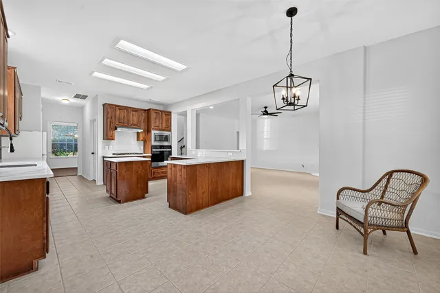 a view of kitchen with sink microwave and cabinets