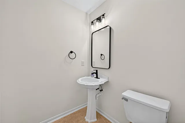 a bathroom with a sink toilet and a mirror