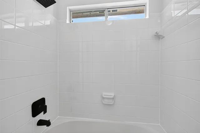 a bathroom with a shower and a bathtub