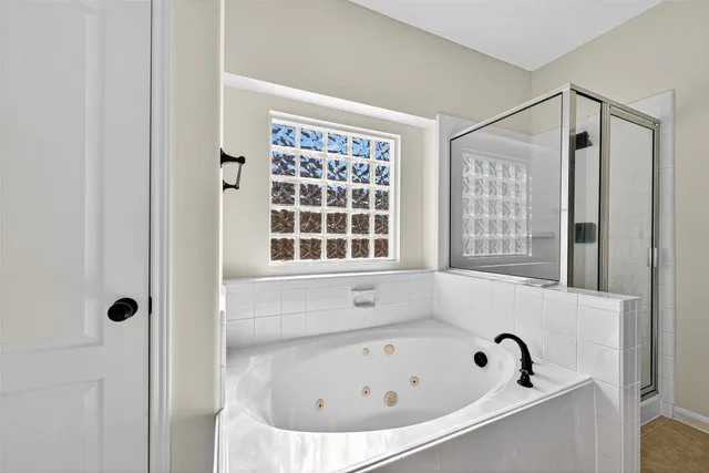 a bathroom with bathtub and window