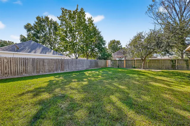 a view of a backyard with a garden and trees
