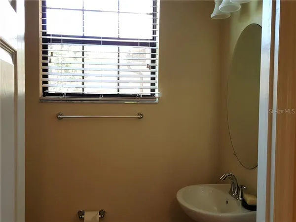 a bathroom with a sink a window and a shower