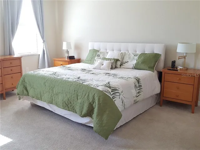 a bedroom with a bed and window