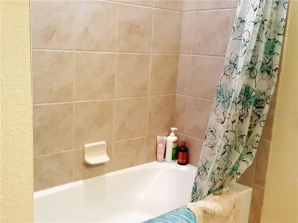 a bathroom with a bathtub and shower