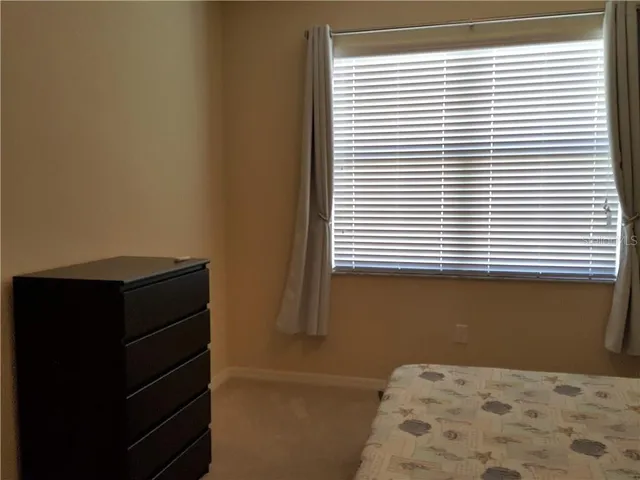 a bathroom with a window and a walk in closet
