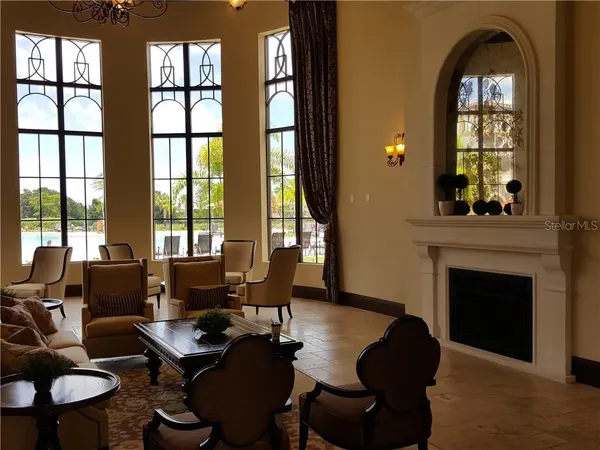 a living room with fireplace furniture and a large window