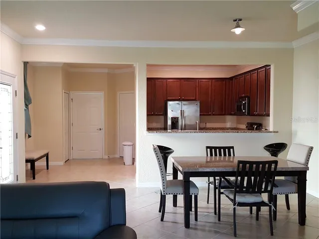 a view of dining room and kitchen with furniture and wooden floor