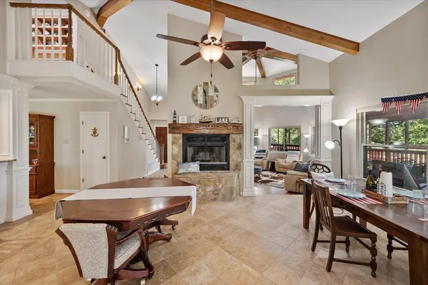 a living room with furniture a fireplace and a chandelier