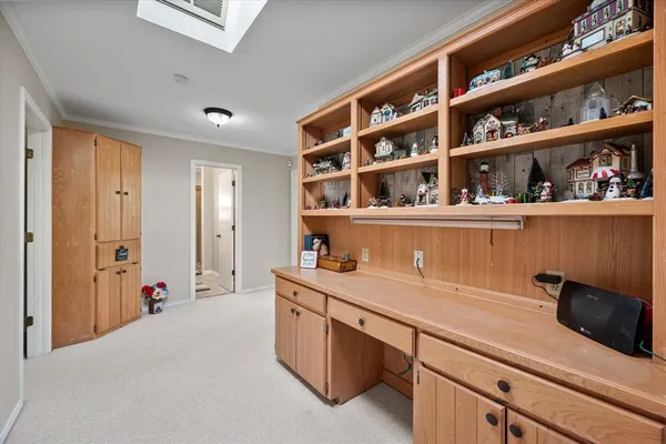 a hallway with cabinets and book shelf