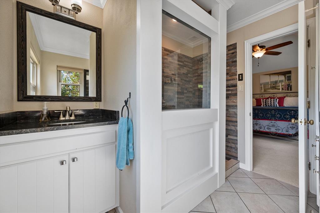 195 Highview Streetman, TX 75859 - Photo 18 of 40 a en suite bathroom with a sink a mirror and a shower