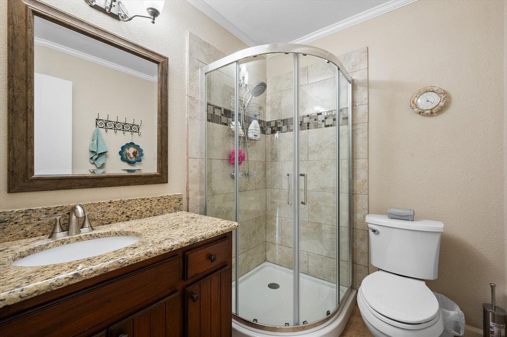 195 Highview Streetman, TX 75859 - Photo 22 of 40 a bathroom with a granite countertop sink toilet and shower