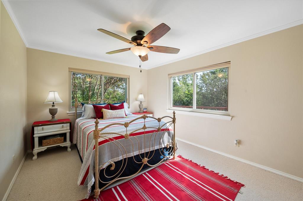195 Highview Streetman, TX 75859 - Photo 24 of 40 a bedroom with a bed and a chandelier
