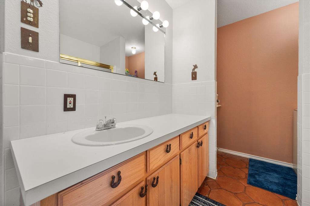 195 Highview Streetman, TX 75859 - Photo 28 of 40 a bathroom with a sink and a mirror