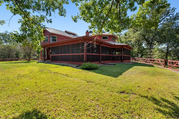 a view of a house with a yard and sitting area