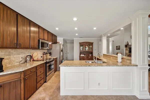 a kitchen with a sink stainless steel appliances and cabinets