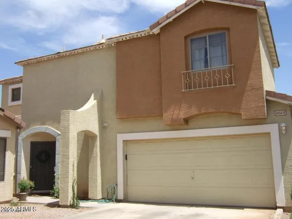 a front view of a house with plants
