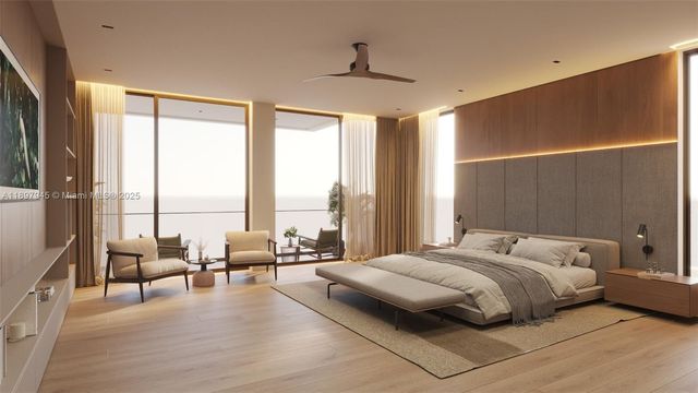 a large bedroom with a bed and large windows