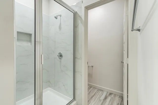 a bathroom with a glass shower door