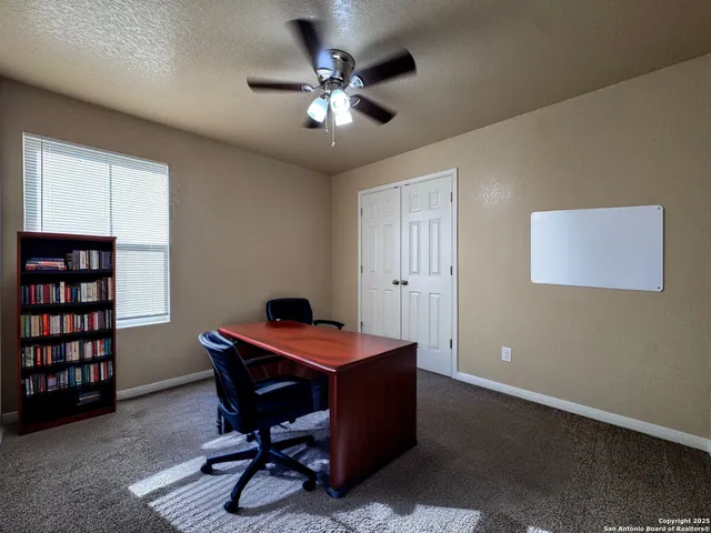 a bathroom with a granite countertop bathtub sink vanity mirror and toilet