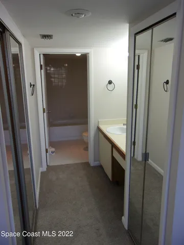 a bathroom with a shower and a sink