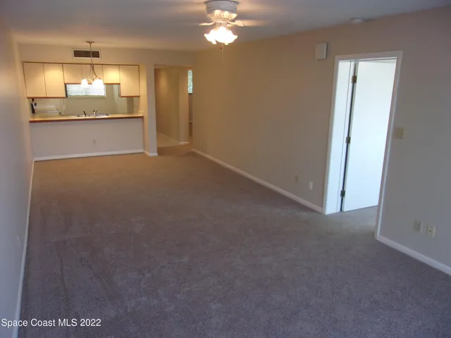 a view of a kitchen with a cabinet a fireplace and chandelier
