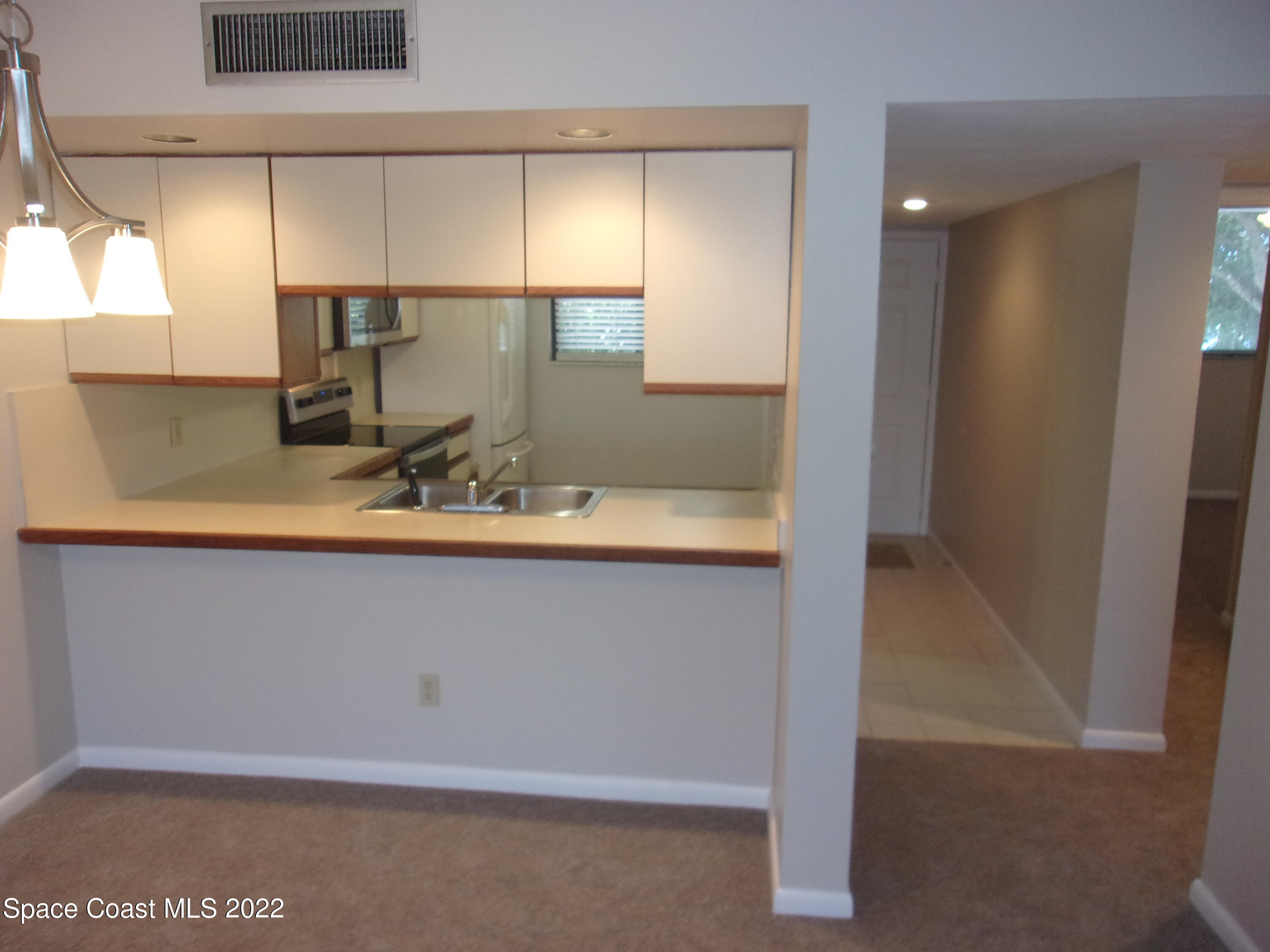 300 Columbia Drive, Unit 3202 Cape Canaveral, FL 32920 - Photo 5 of 16 a bathroom with a sink and a mirror