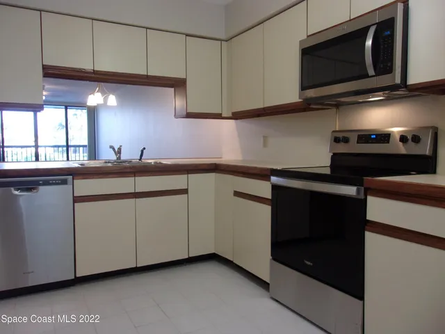 a kitchen with stainless steel appliances granite countertop a sink and a microwave