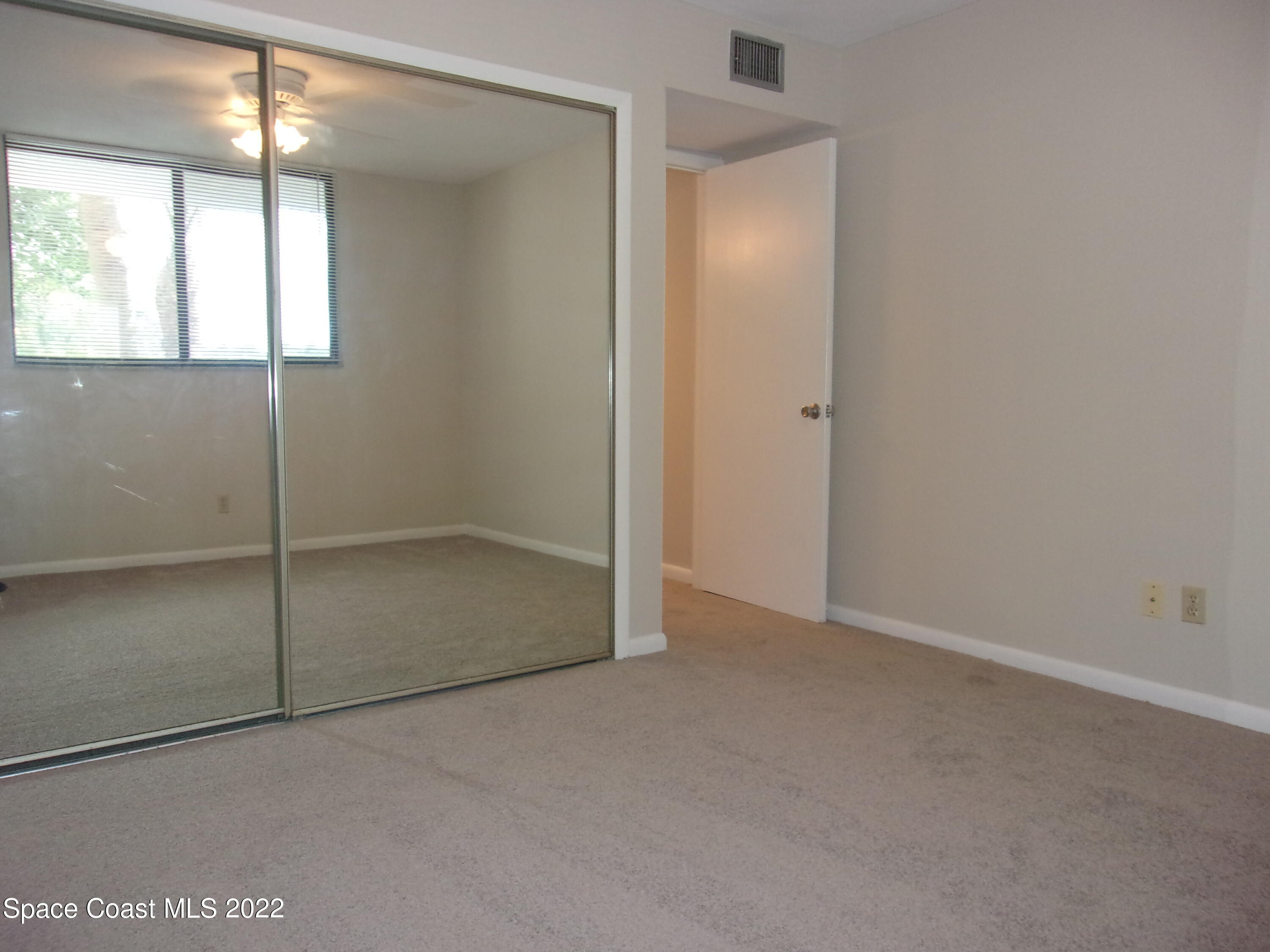 300 Columbia Drive, Unit 3202 Cape Canaveral, FL 32920 - Photo 7 of 16 an empty room with windows and closet