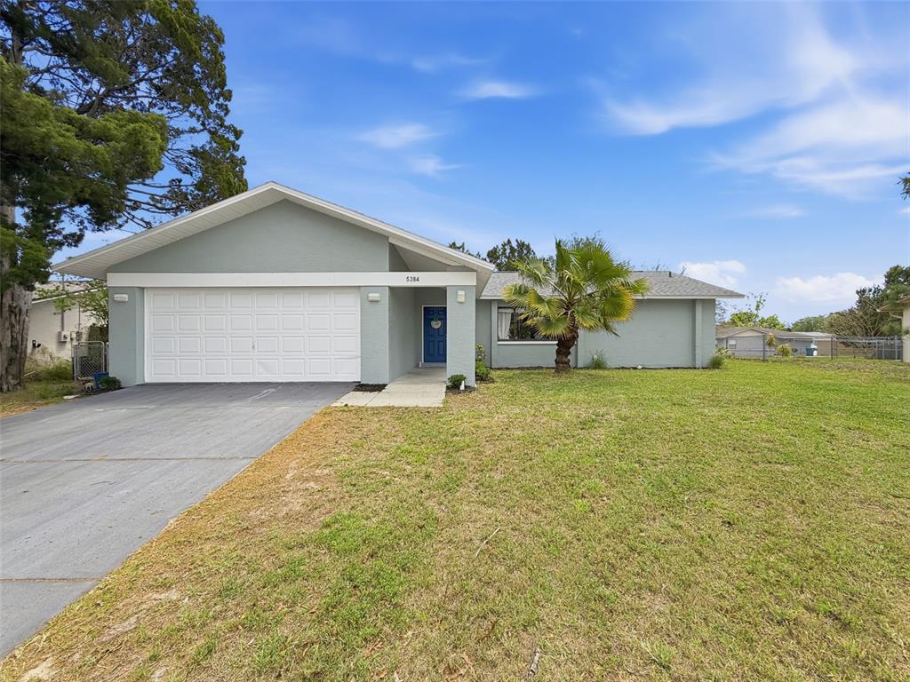 5384 Baldock Avenue Spring Hill, FL 34608 - Photo 10 of 51 a front view of a house with a yard