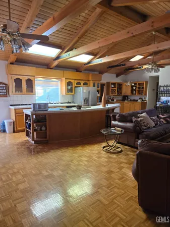 a living room with furniture window and kitchen view