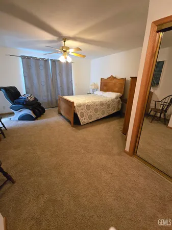 a bedroom with a bed and a couch