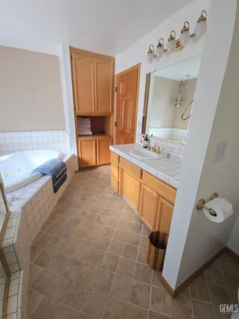 a bathroom with a tub sink and mirror