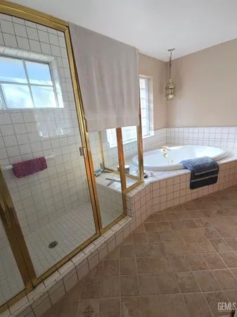 a bathroom with a bathtub and a shower