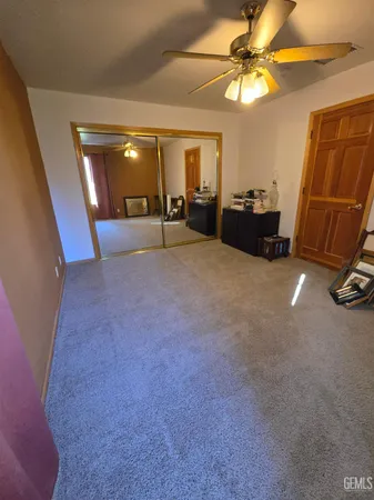 a view of a livingroom with a furniture and a ceiling fan