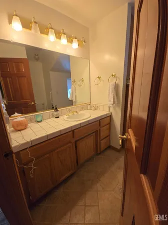 a bathroom with a sink a vanity and a mirror