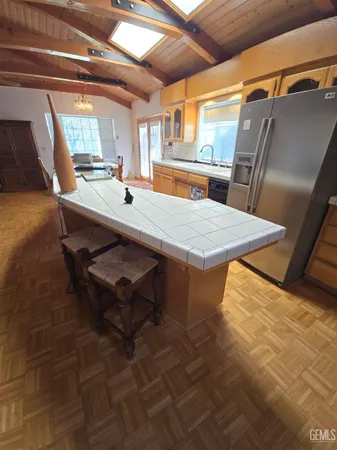 a dining room with a wooden floor and next to a window