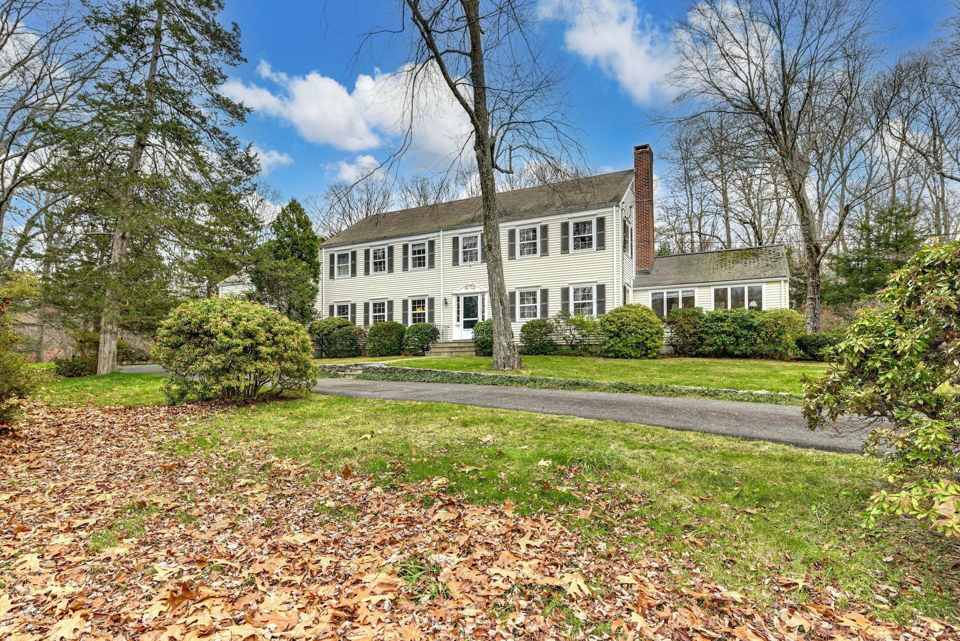 113 Logan Road New Canaan, CT 06840 - Photo 1 of 27 a front view of a house with a yard