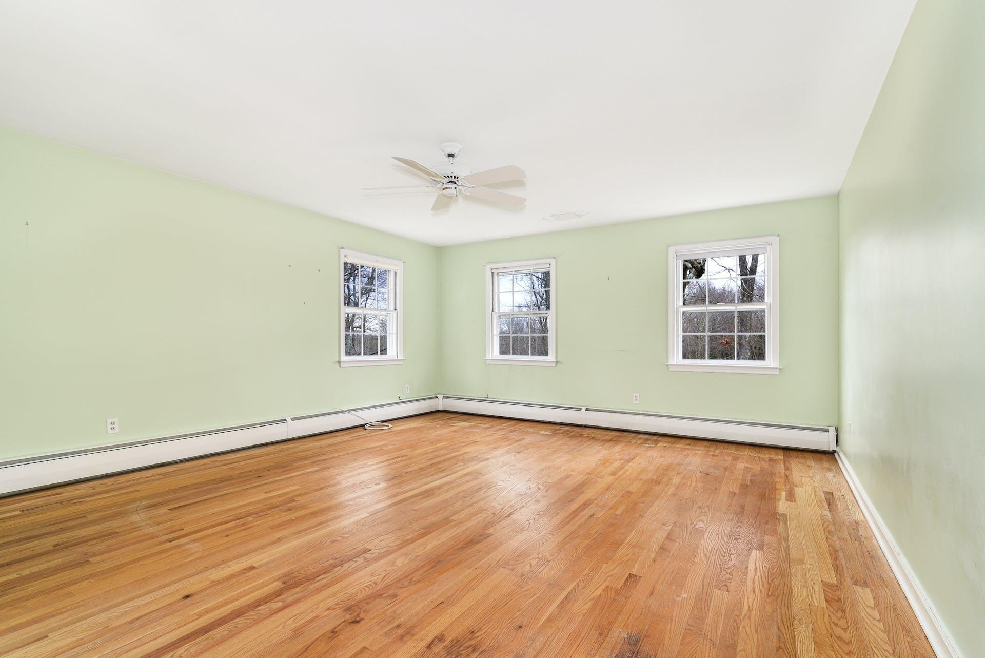 113 Logan Road New Canaan, CT 06840 - Photo 15 of 27 a view of an empty room with wooden floor and a window