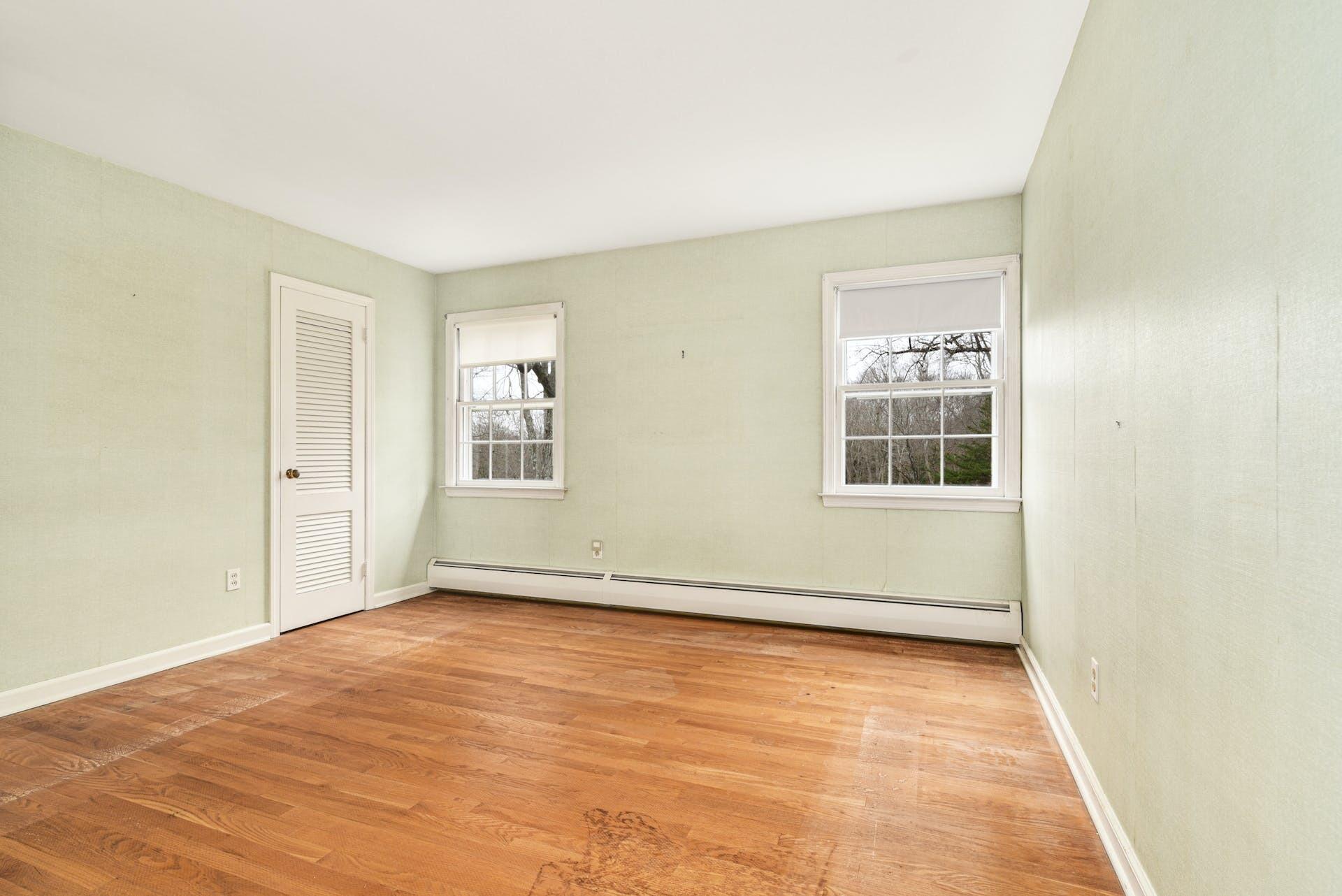 113 Logan Road New Canaan, CT 06840 - Photo 18 of 27 an empty room with wooden floor and windows