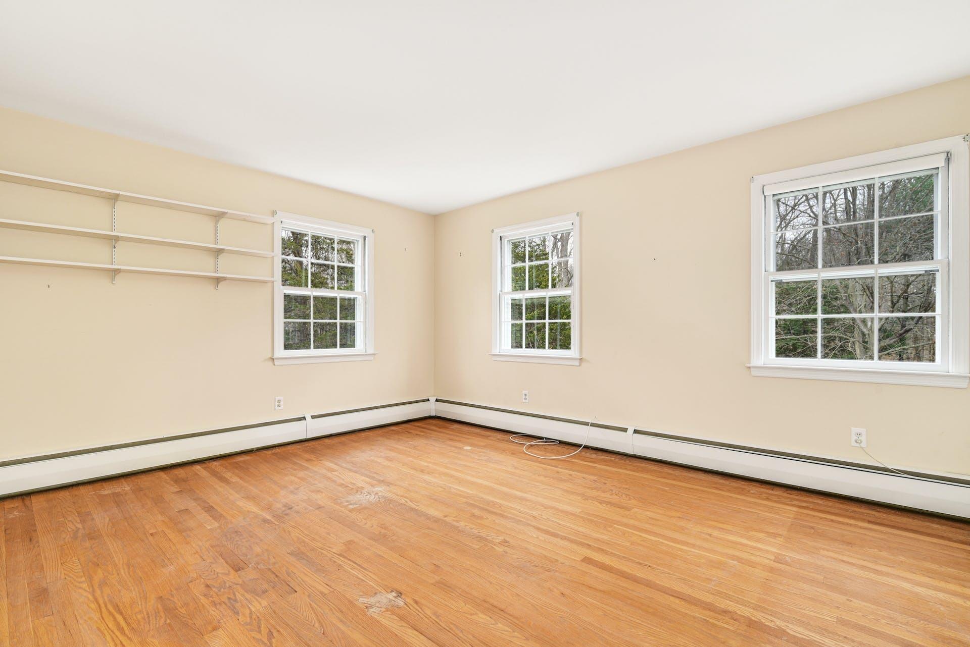 113 Logan Road New Canaan, CT 06840 - Photo 20 of 27 an empty room with wooden floor and windows