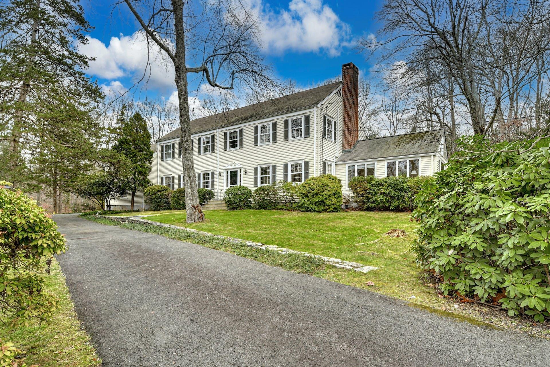 113 Logan Road New Canaan, CT 06840 - Photo 2 of 27 a view of a house with a yard and potted plants