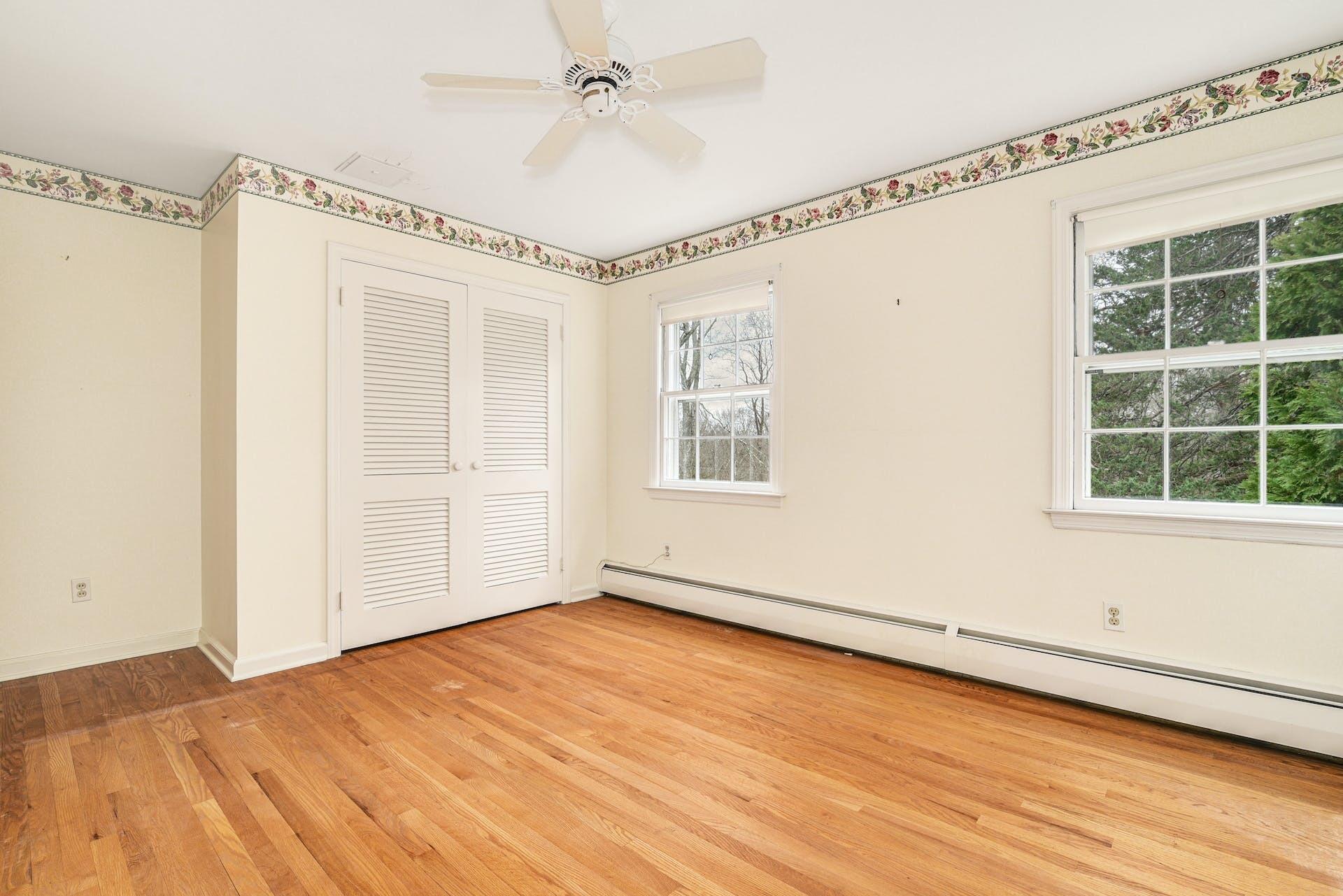 113 Logan Road New Canaan, CT 06840 - Photo 21 of 27 a view of an empty room with a window and wooden floor
