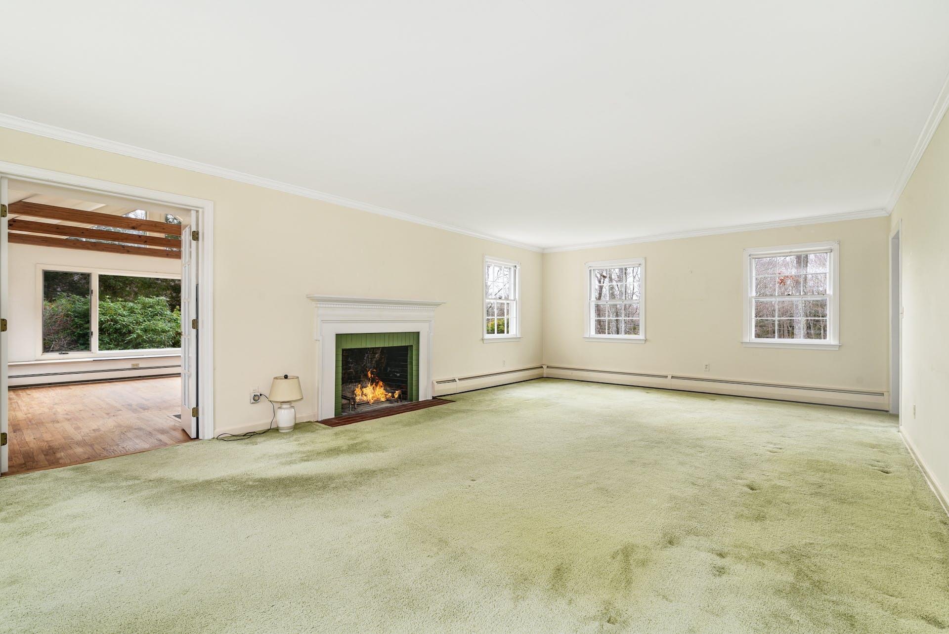 113 Logan Road New Canaan, CT 06840 - Photo 4 of 27 an empty room with windows and fireplace
