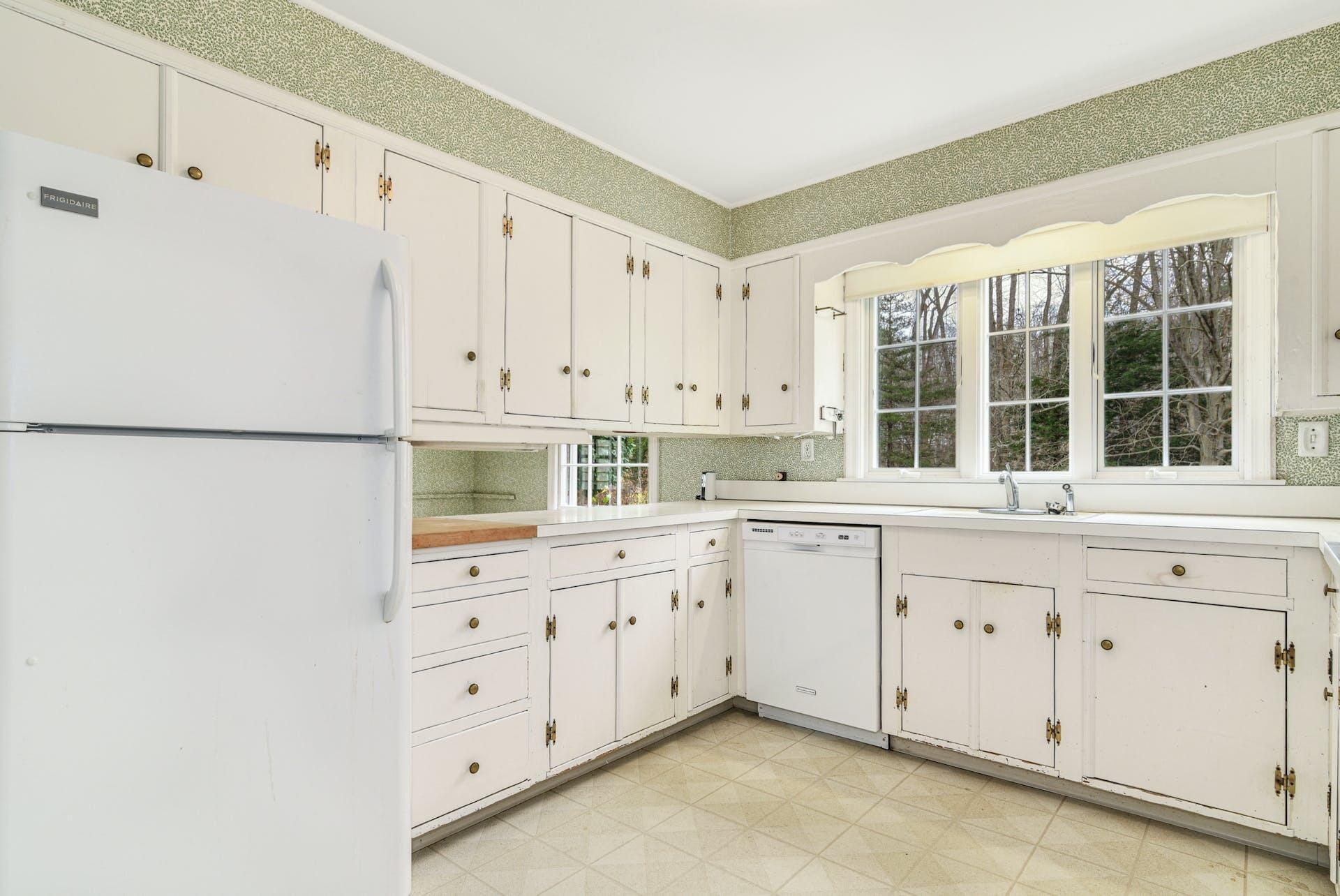 113 Logan Road New Canaan, CT 06840 - Photo 7 of 27 a kitchen with granite countertop white cabinets and sink