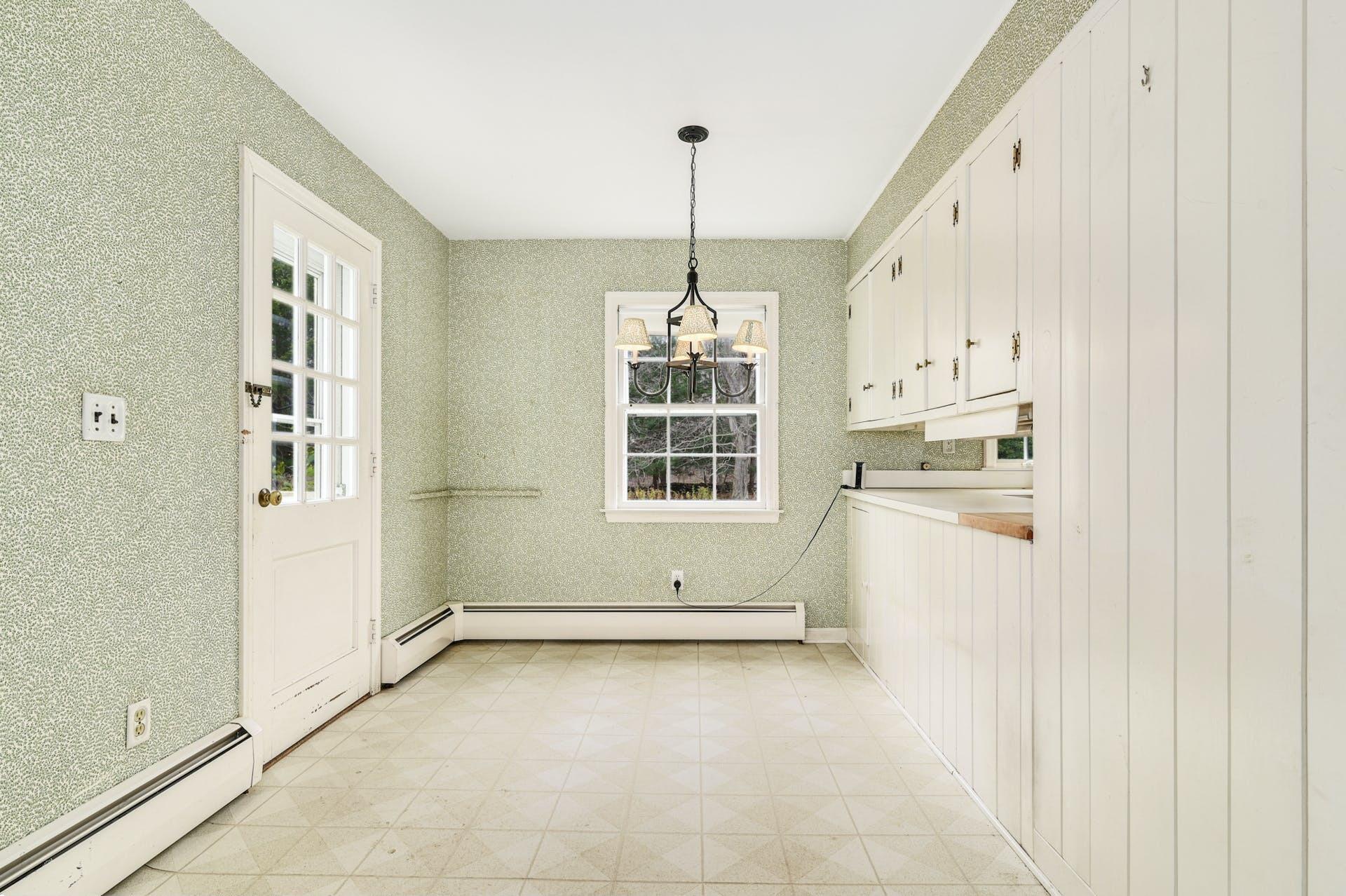 113 Logan Road New Canaan, CT 06840 - Photo 9 of 27 a view of a kitchen with dishwasher and white cabinets