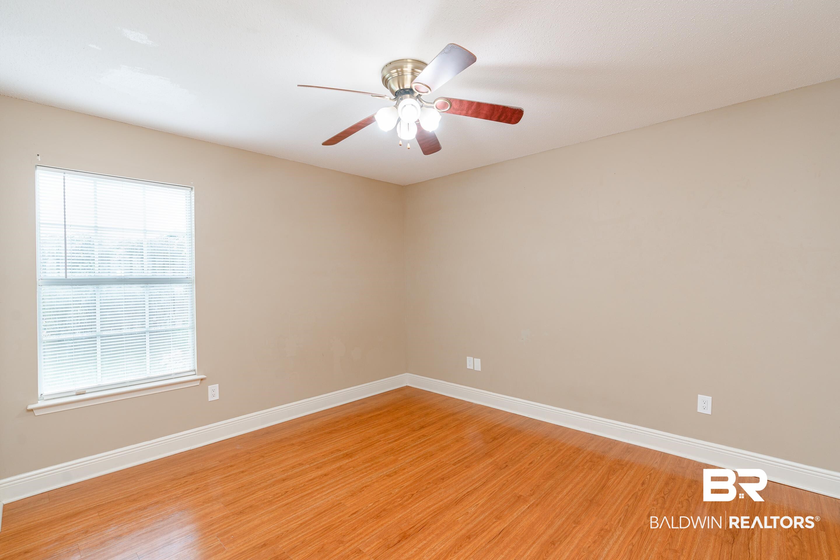 23 Old Mill Court Mobile, AL 36608 - Photo 27 of 37 Empty room featuring a healthy amount of sunlight, light hardwood / wood-style floors, and ceiling fan
