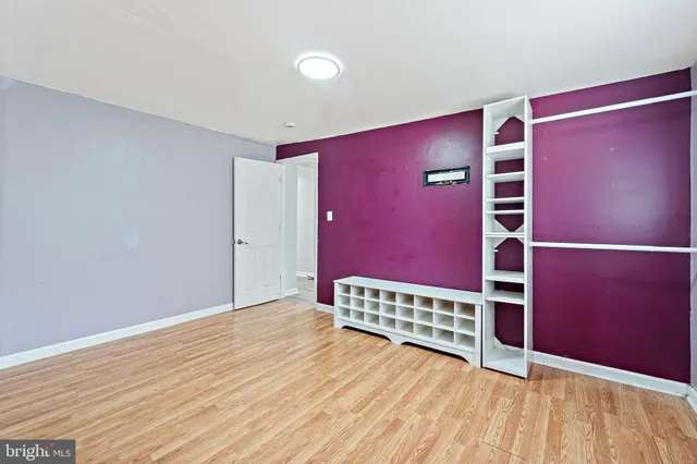 a view of room with wooden floor and windows