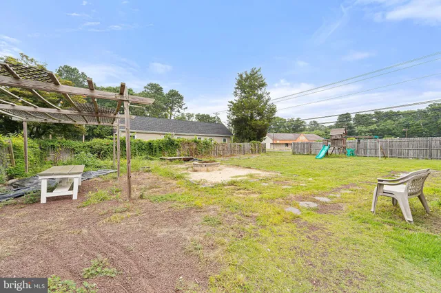 a white house that has a tree in front of it