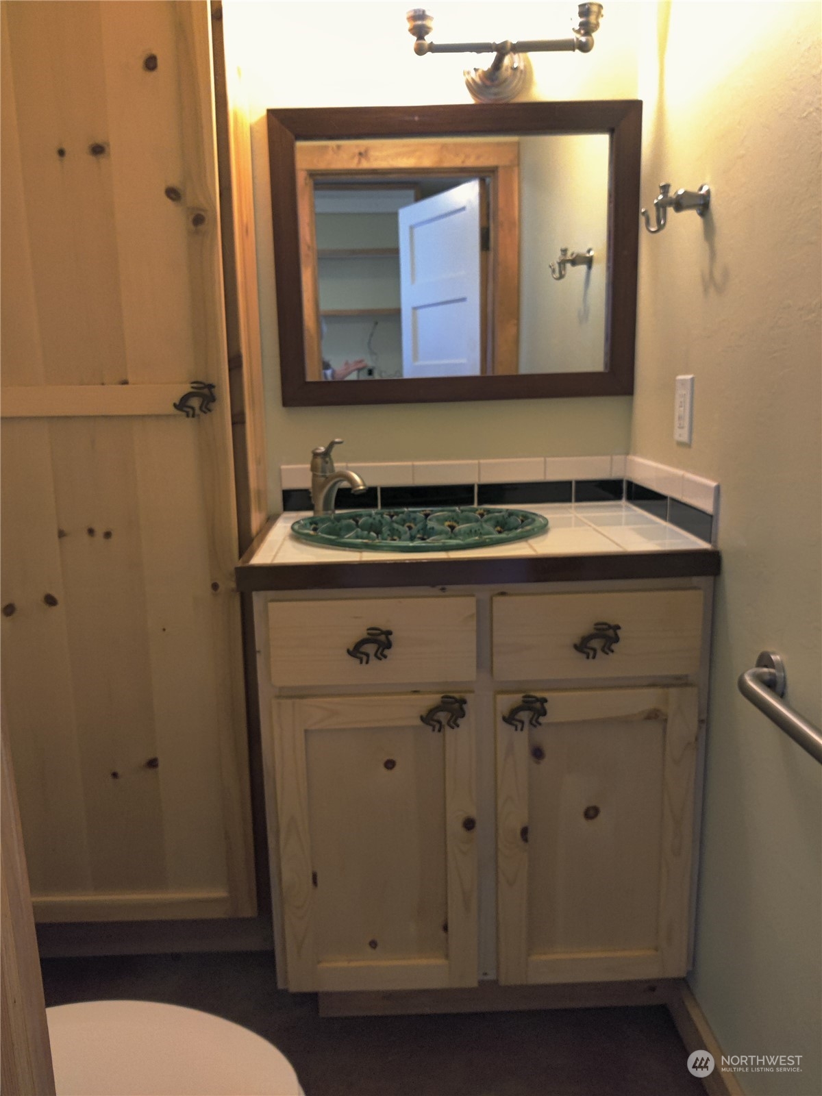 18142 Peter Burns Road Mount Vernon, WA 98274 - Photo 13 of 39 a bathroom with a sink a mirror and cabinets